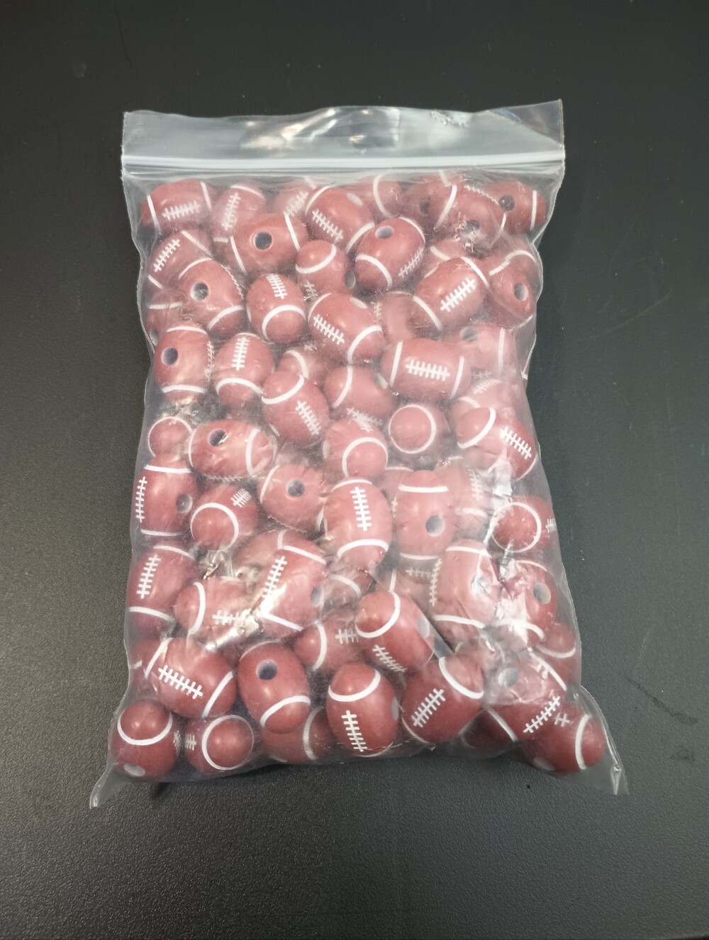 Plastic Football Beads. Lot Of 99